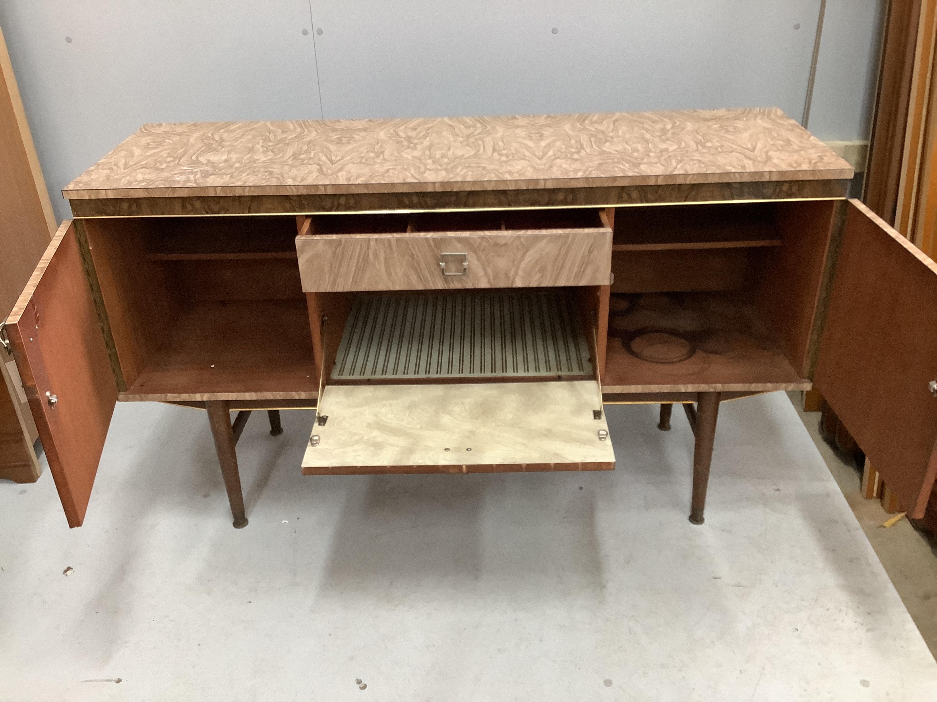 A 1960’s melamine sideboard, width 136cm, depth 43cm, height 78cm